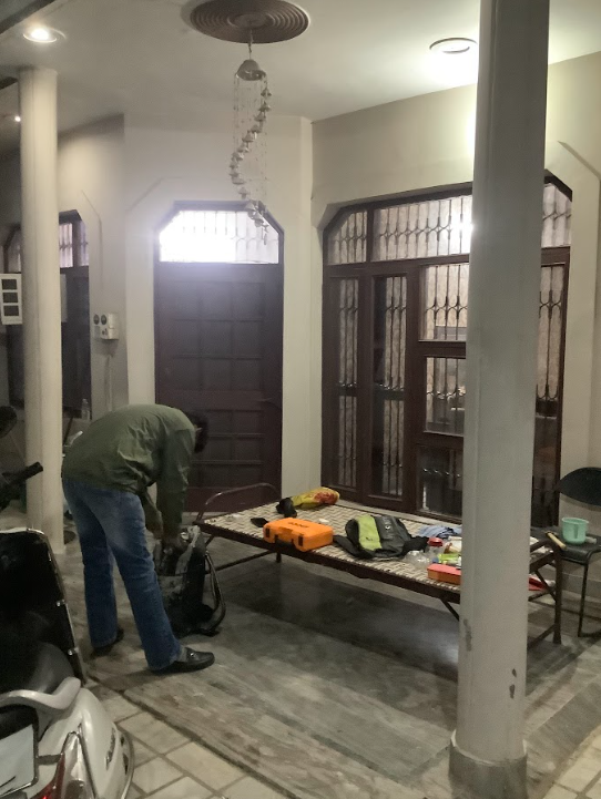 OPC technician preparing equipment on residential porch
